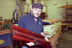 Dean Dwyer holding the Mahogany PorchBoard Floor Bass
